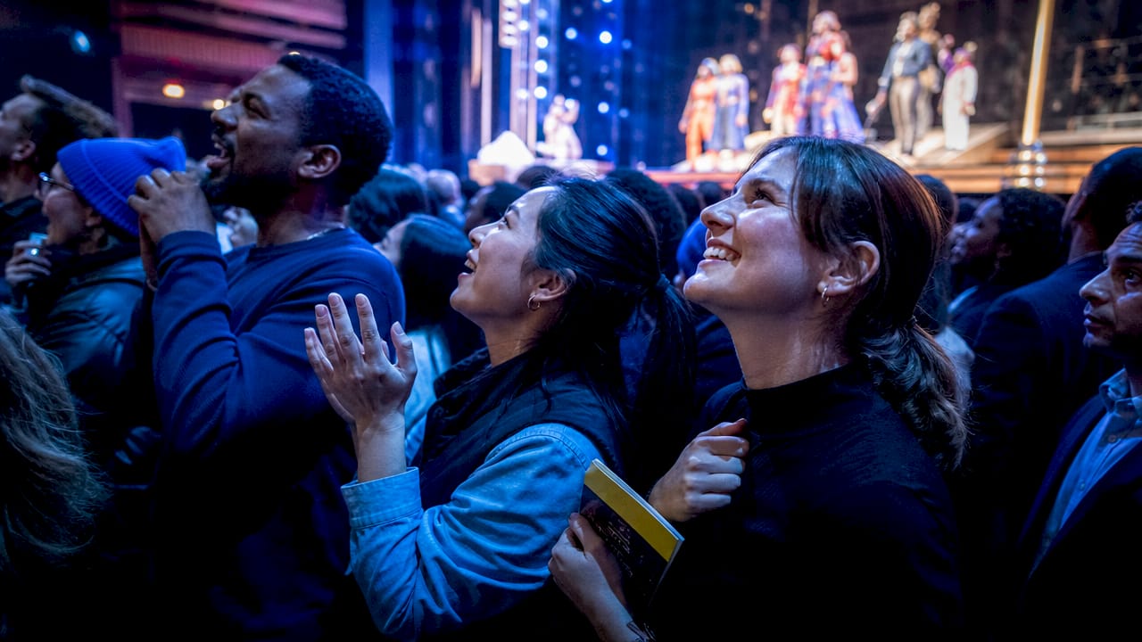 Standing room patrons watching Broadway performance