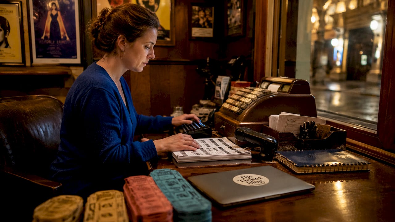 Ticket agent processing private sales at box office