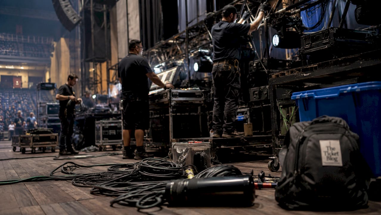 Backstage crew setting up concert equipment