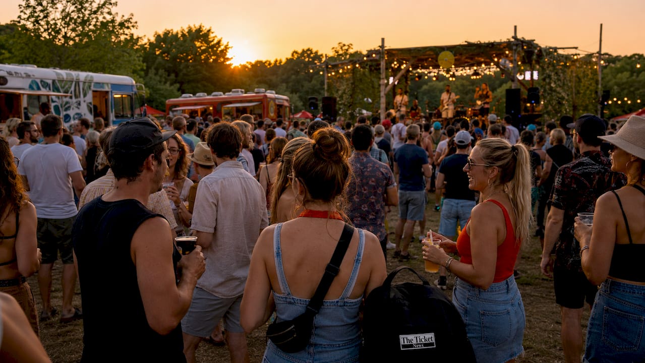 Crowd enjoying outdoor roots music festival performance.