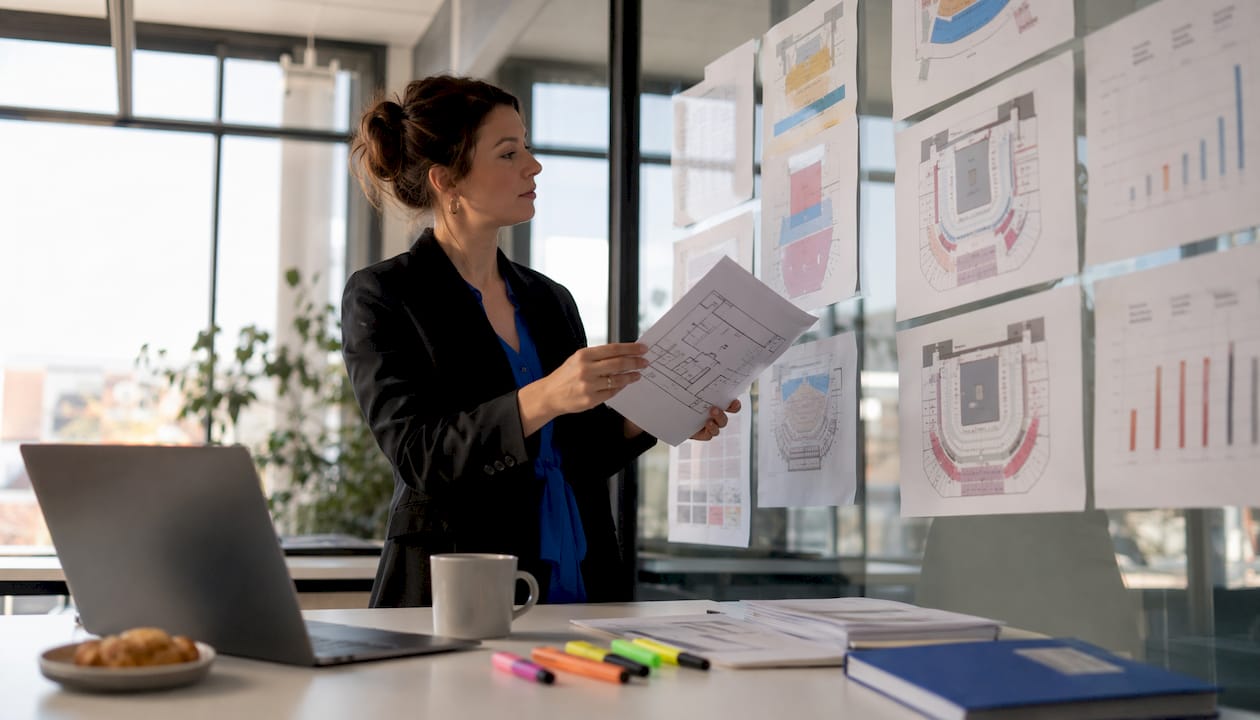 Event promoter reviewing seating charts and sales data