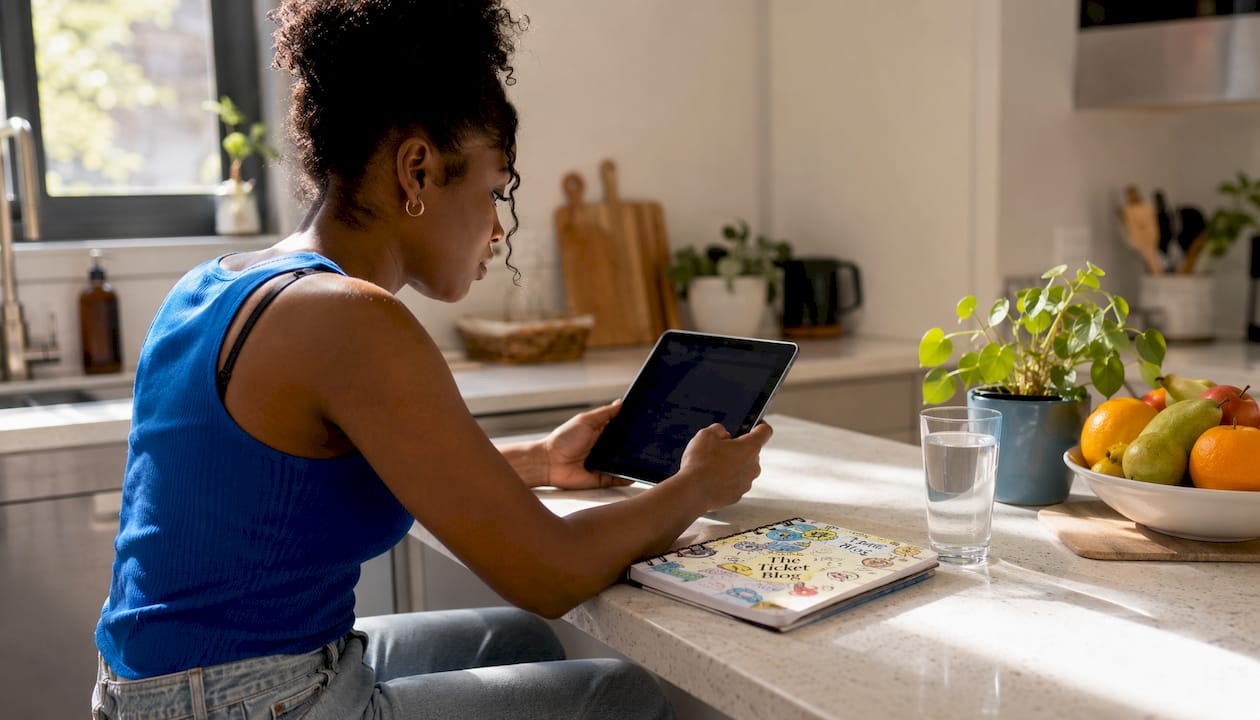 Woman checking ticket prices at home on tablet