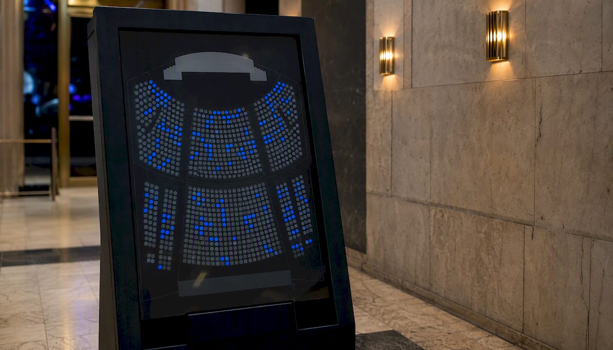 Concert seat map with blue dots on ticket kiosk screen