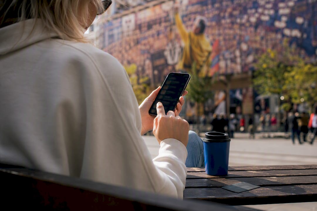 Hands interacting with phone and ticket details