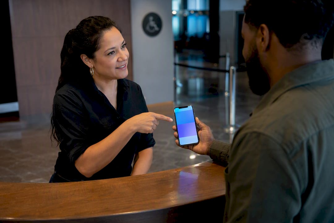 Staff helping attendee access mobile ticket