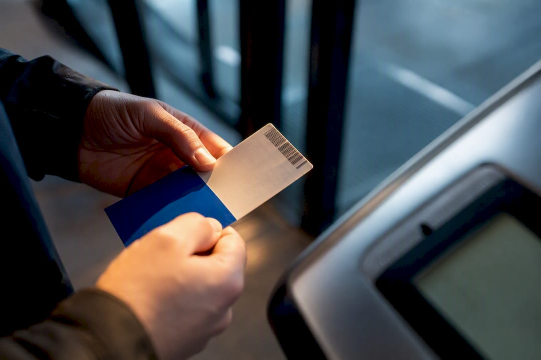 Buyer inspecting ticket beside entry scanner