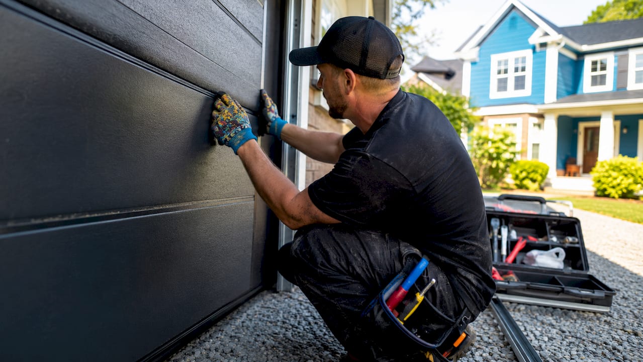 Contractor installing garage door panels