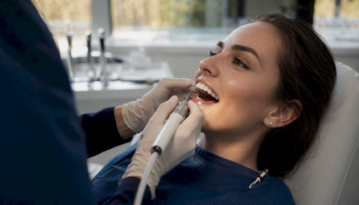 Close-up dental plaque removal on teeth