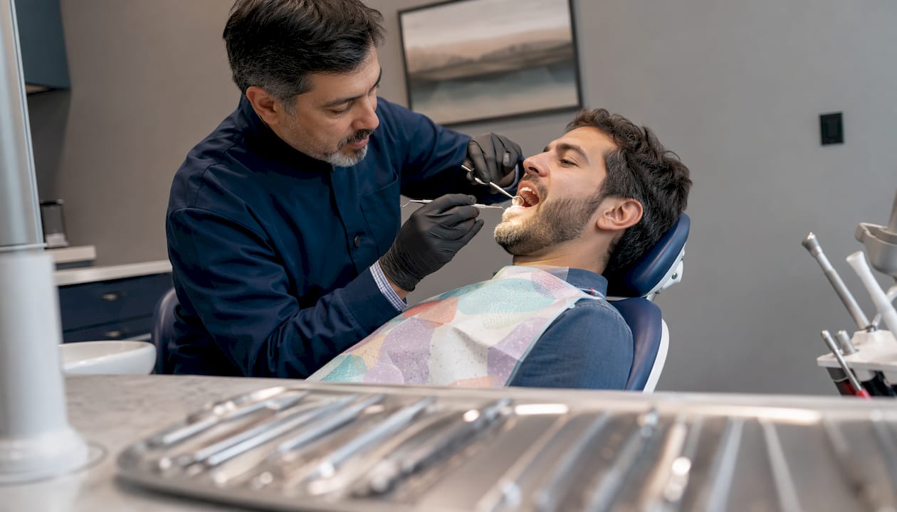 Dentist performing oral health checkup in clinic