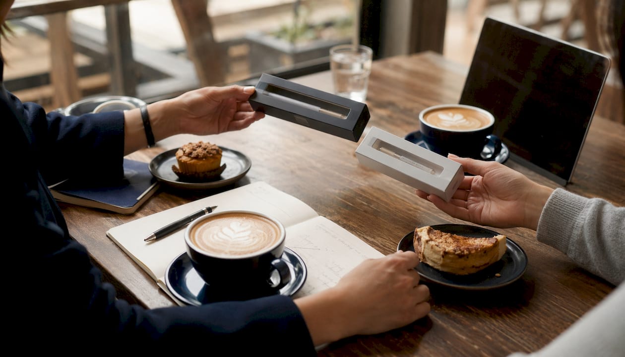 Hands comparing teeth whitening product boxes