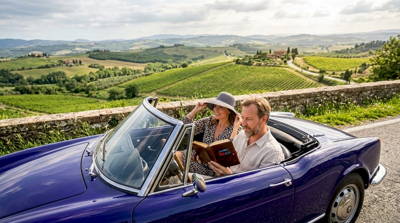 Couple in vintage Ferrari Tuscany