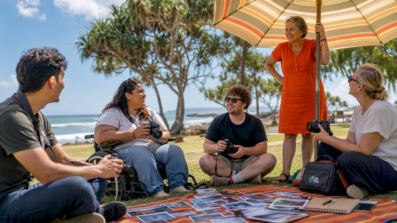 Group participatory photography workshop in a park