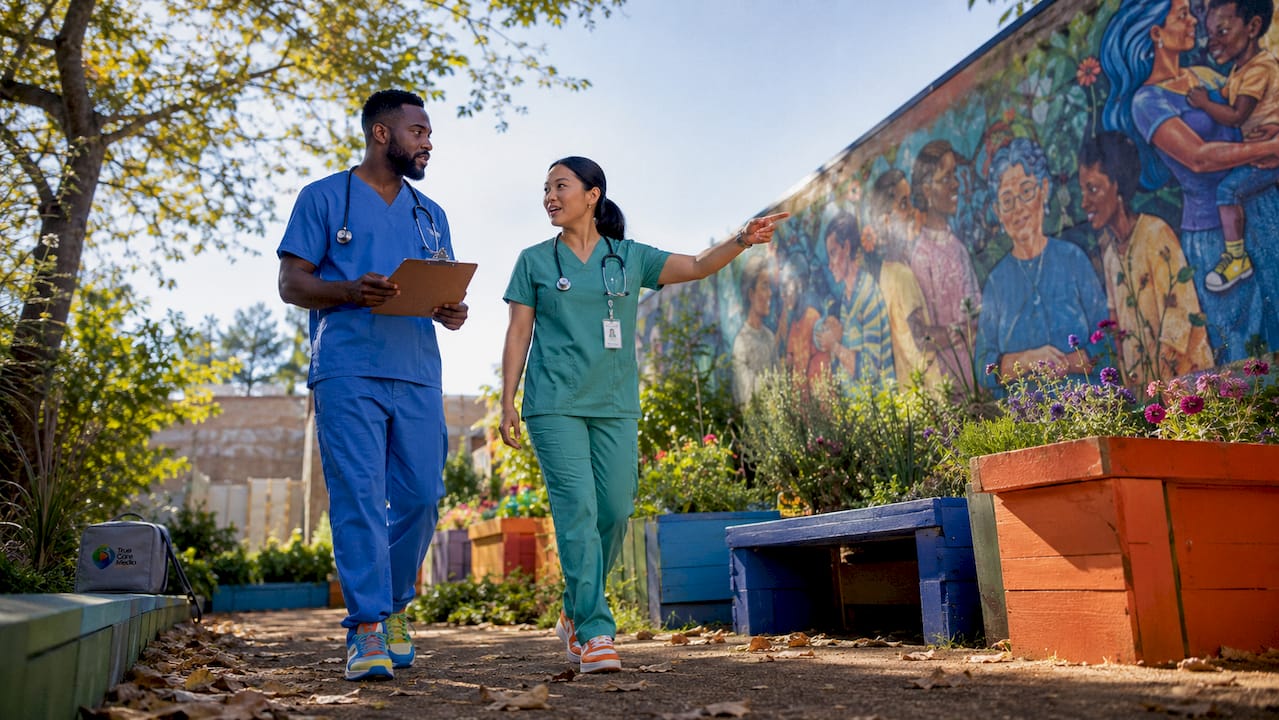 Healthcare workers walking by storytelling art installations