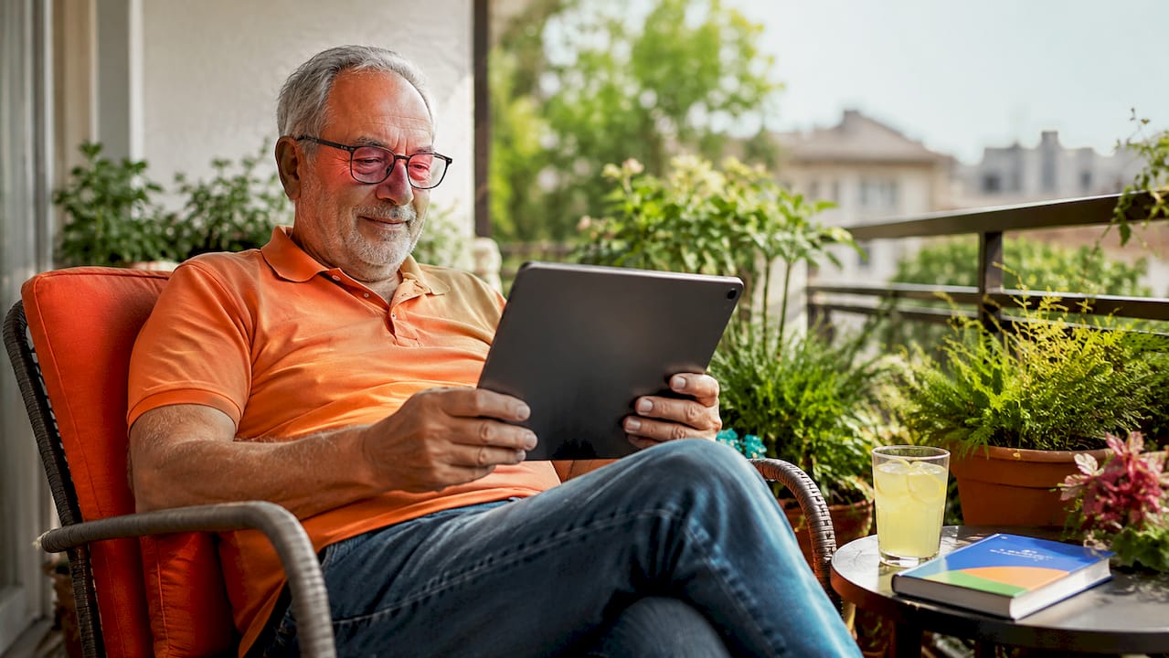 Elderly man watching healthcare video at home