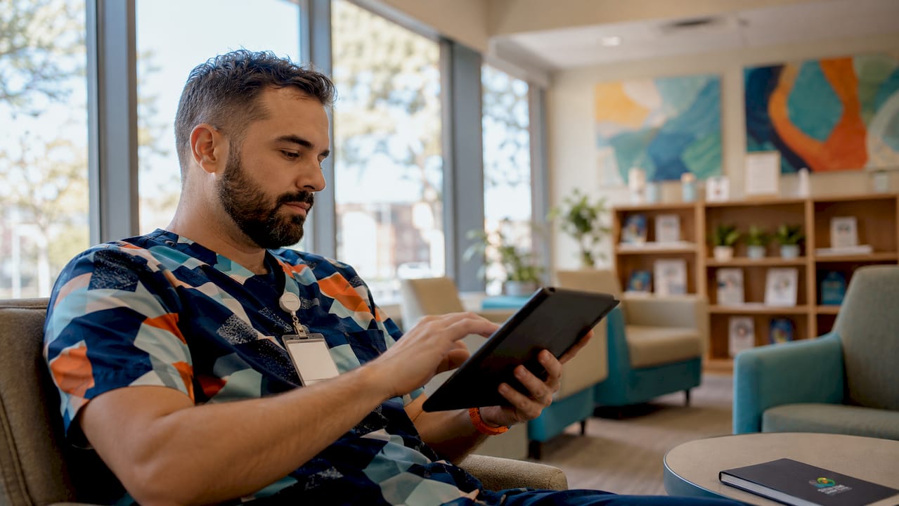 Doctor using tablet to manage social media platforms