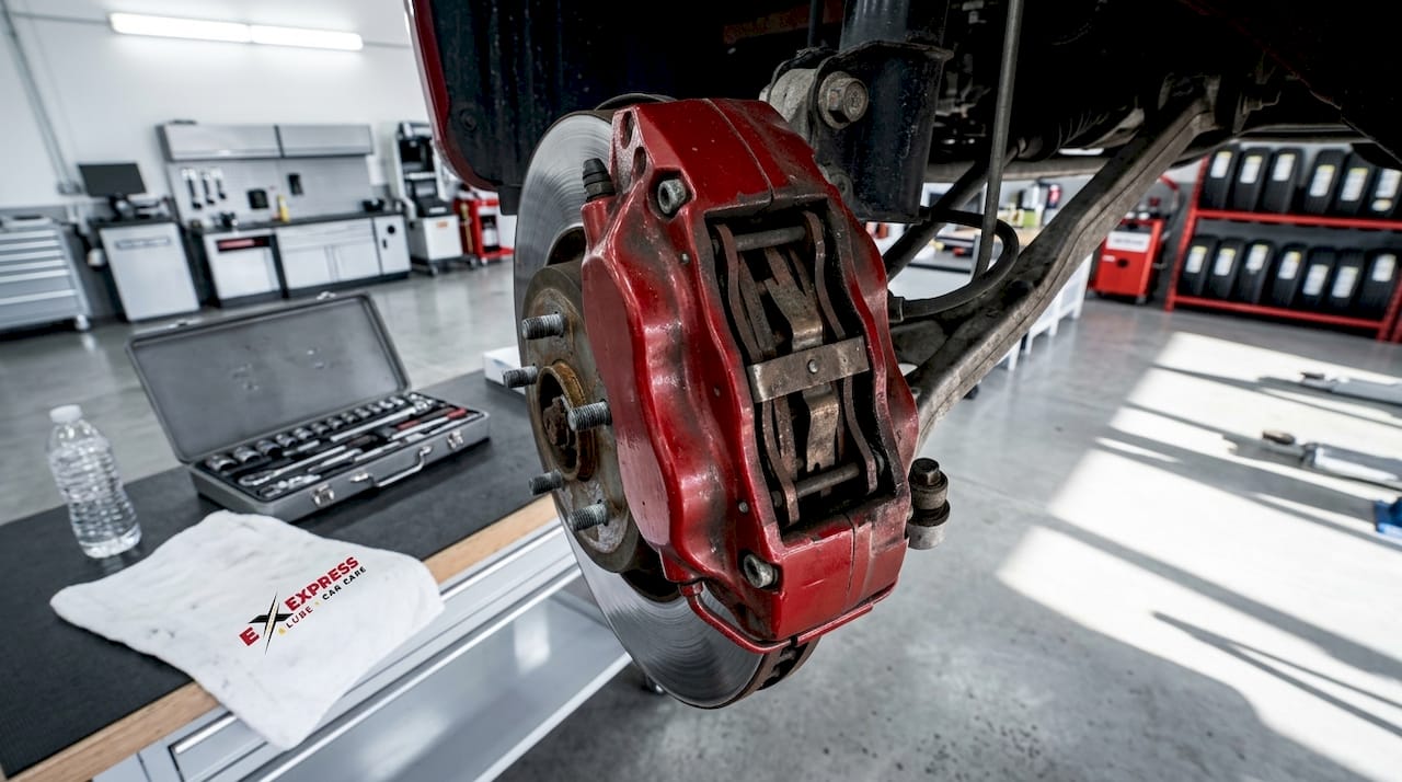 Fixed brake caliper on vehicle suspension