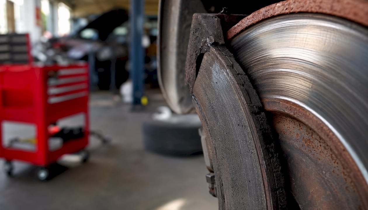 Close-up of unevenly worn brake pad