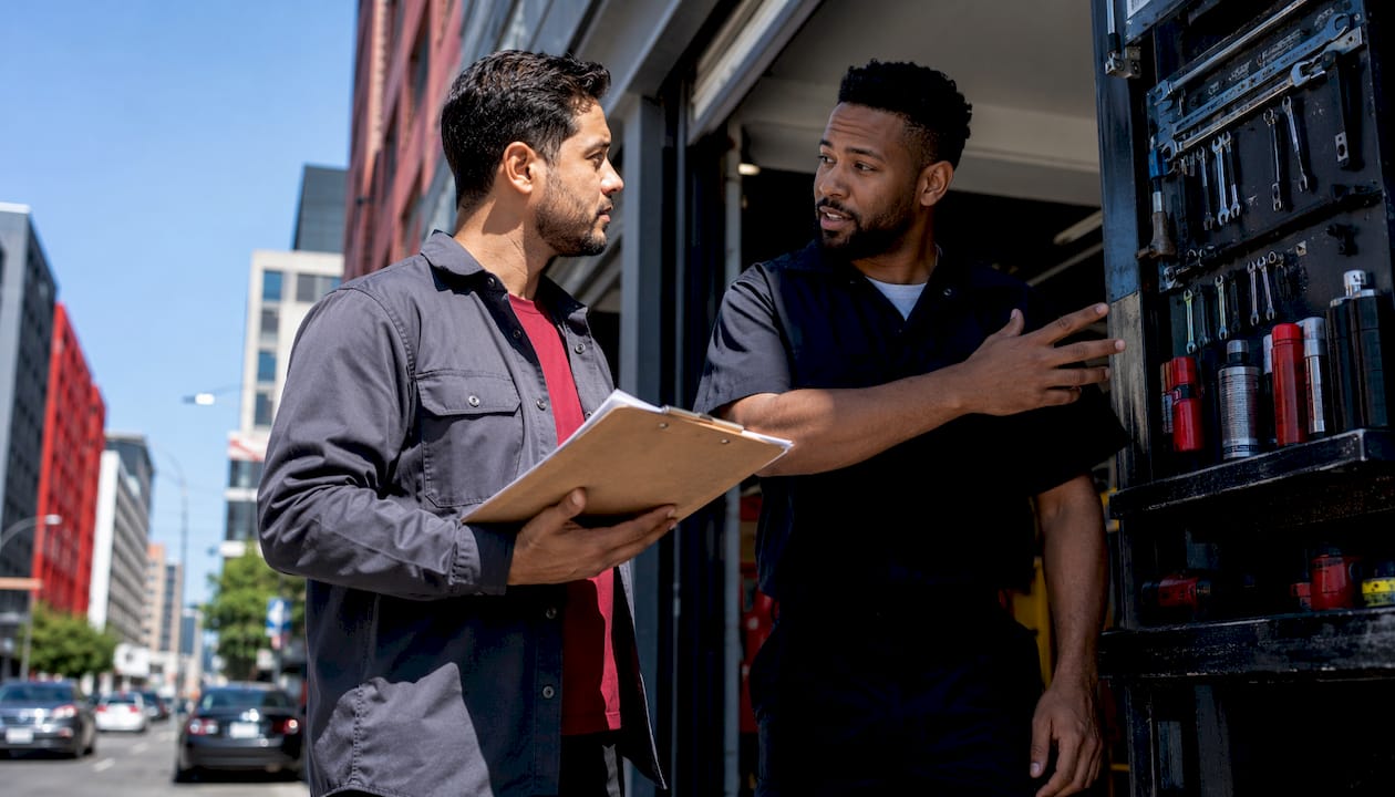 Customers discussing mechanic shop credentials