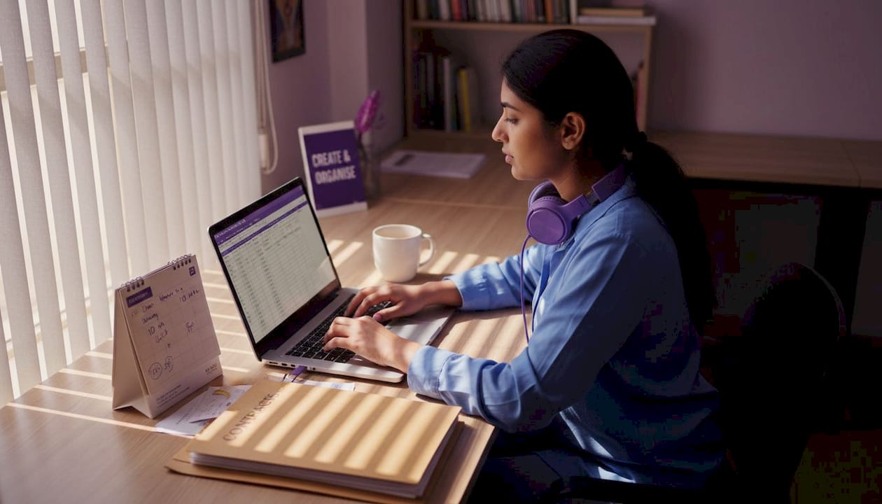 Event coordinator updating venue spreadsheet