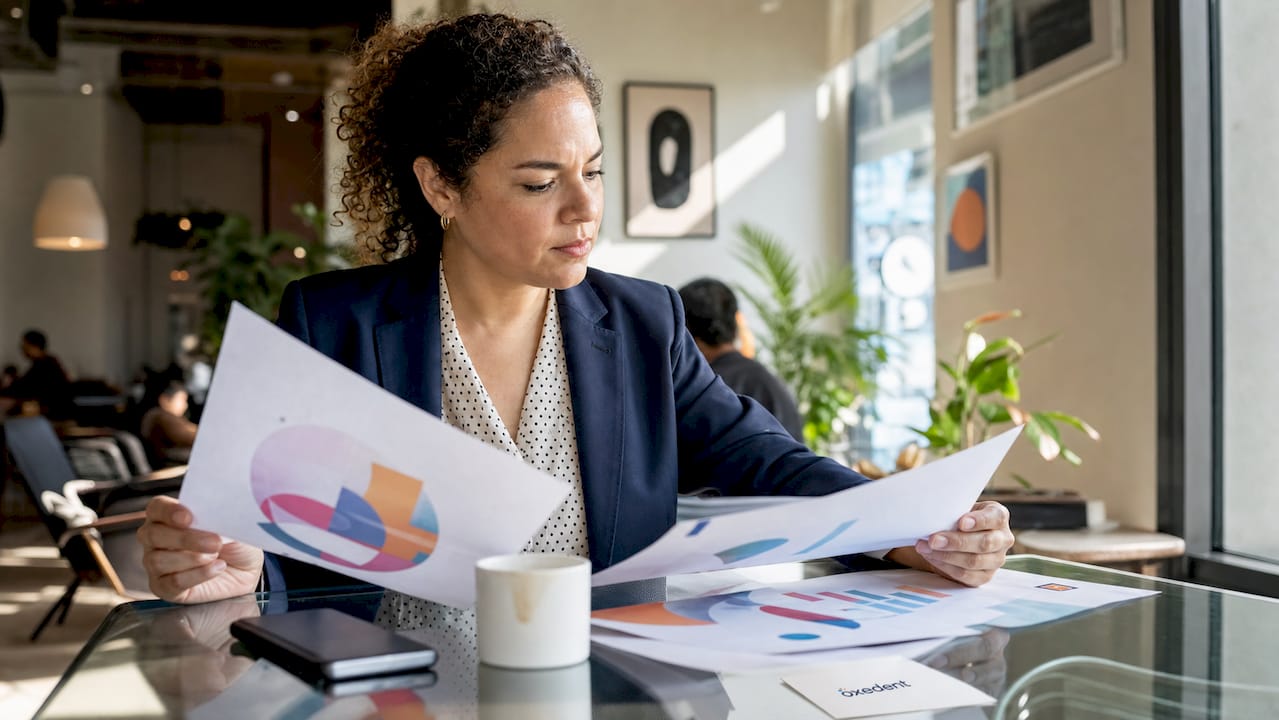PPC manager reviewing printed reports in office