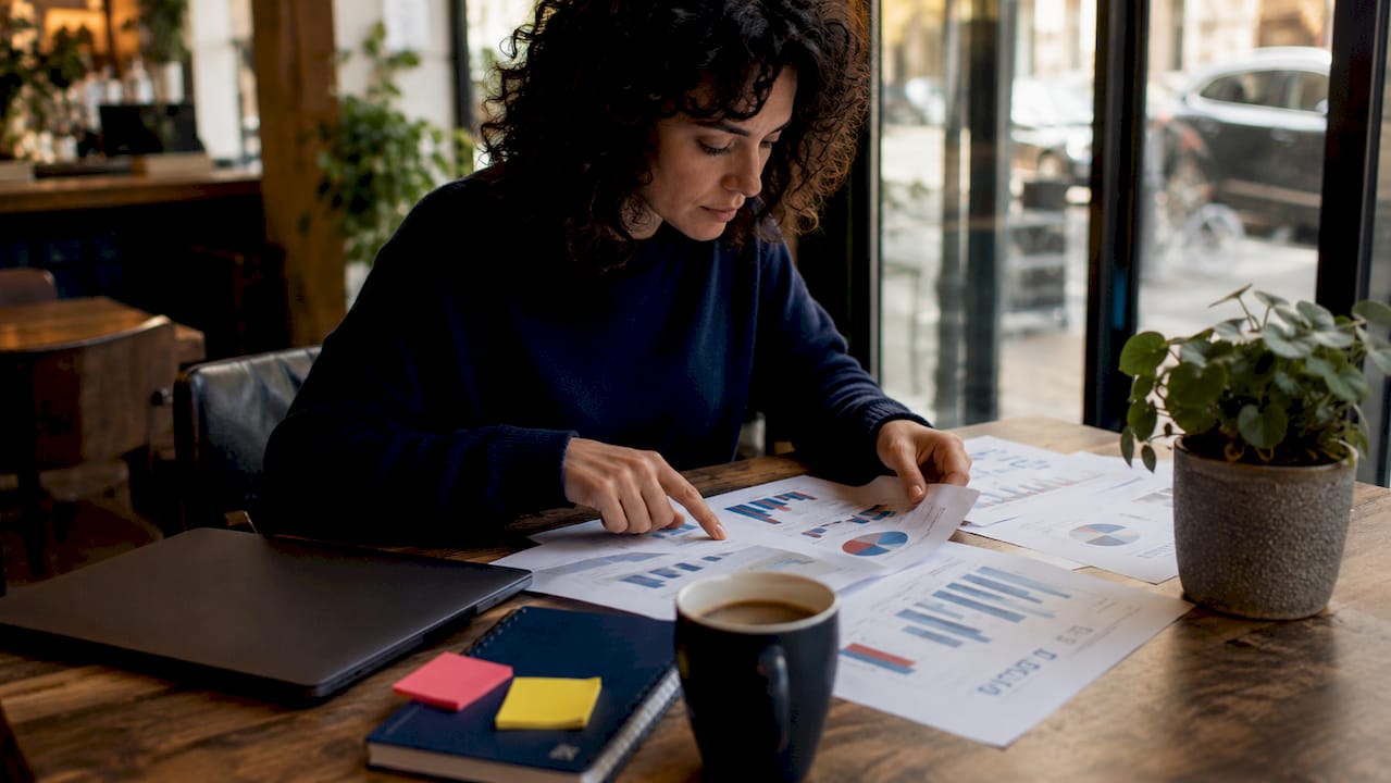 Marketing analyst reviewing PPC reports at desk