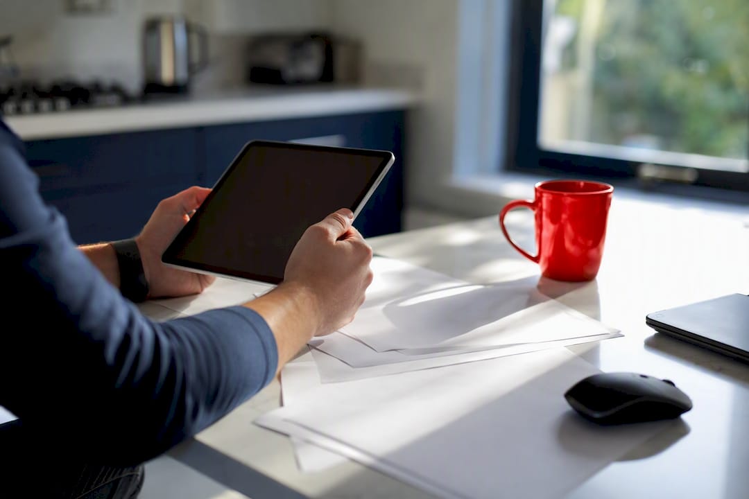 Hands holding tablet with campaign notes