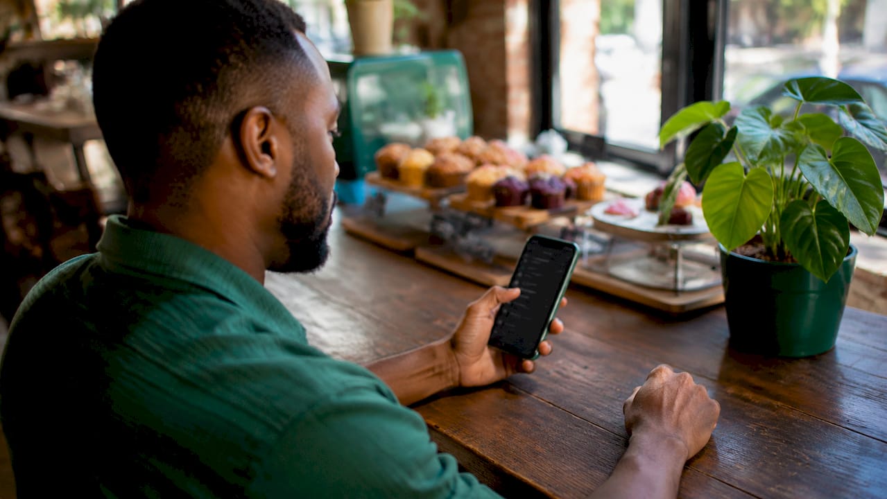 Hands navigating WhatsApp Business app on smartphone