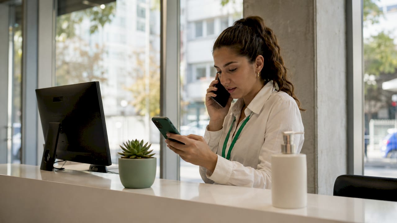 Dental clinic receptionist scheduling appointments digitally