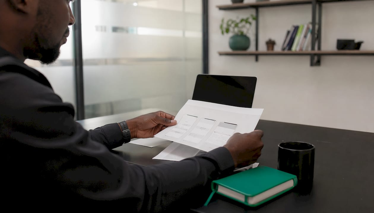 Hands reviewing payment alert templates