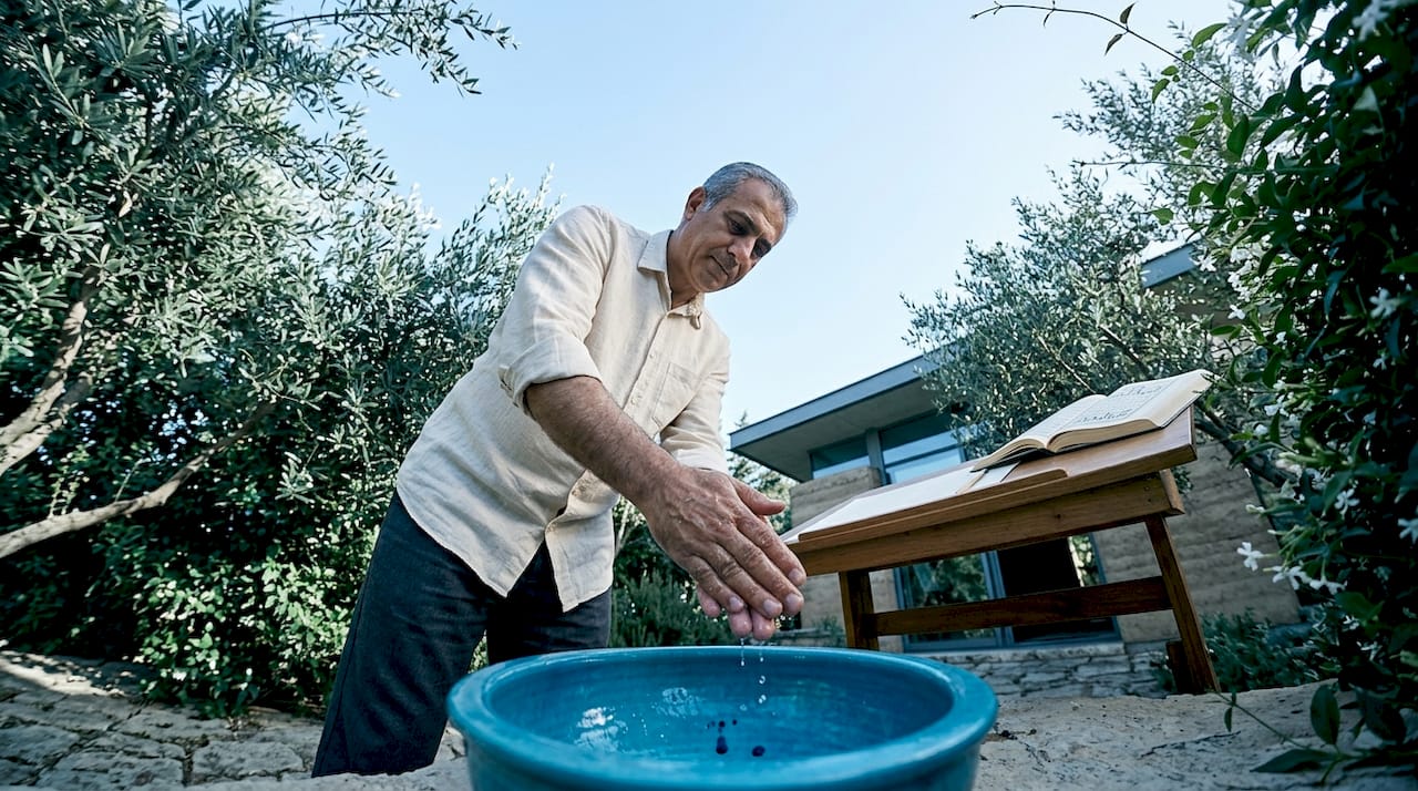 Calligrapher ritual handwashing before script