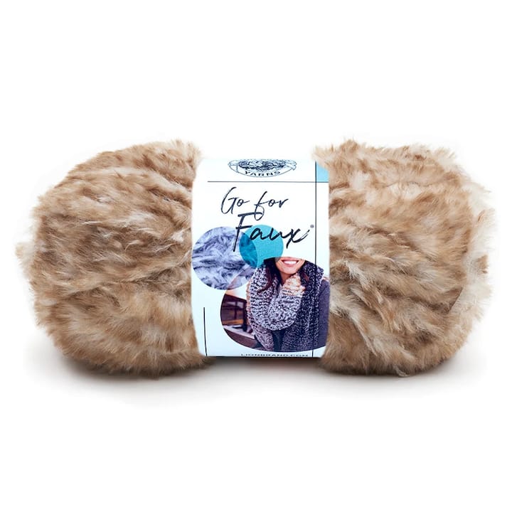 Woman knitting metallic novelty yarn scarf indoors