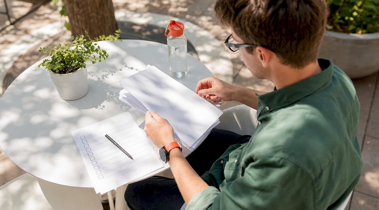 Novice teacher reviewing support materials in school office