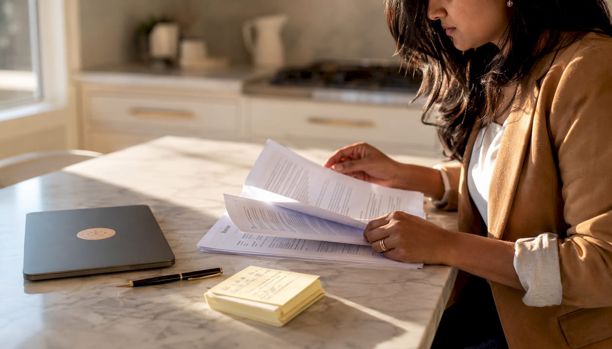 Hands organizing bilingual legal divorce documents at desk