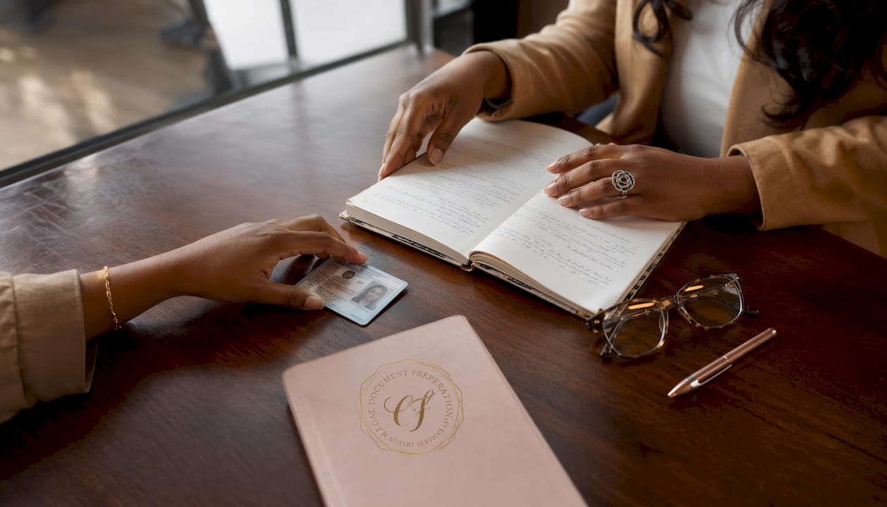 Hands verifying ID and notary journal
