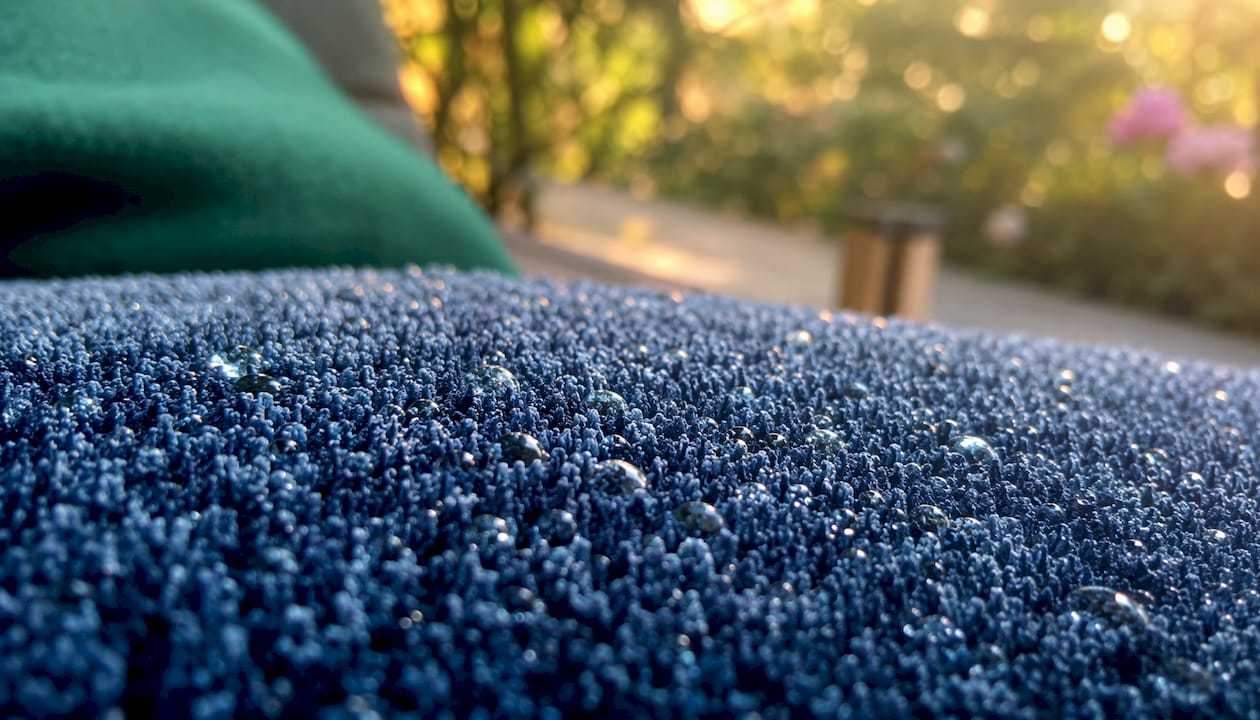 Detalle en primer plano de una tela aterciopelada con gotas que ha absorbido.