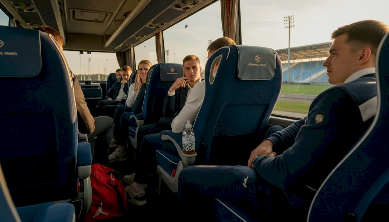 Athletes relaxing inside full-size charter bus