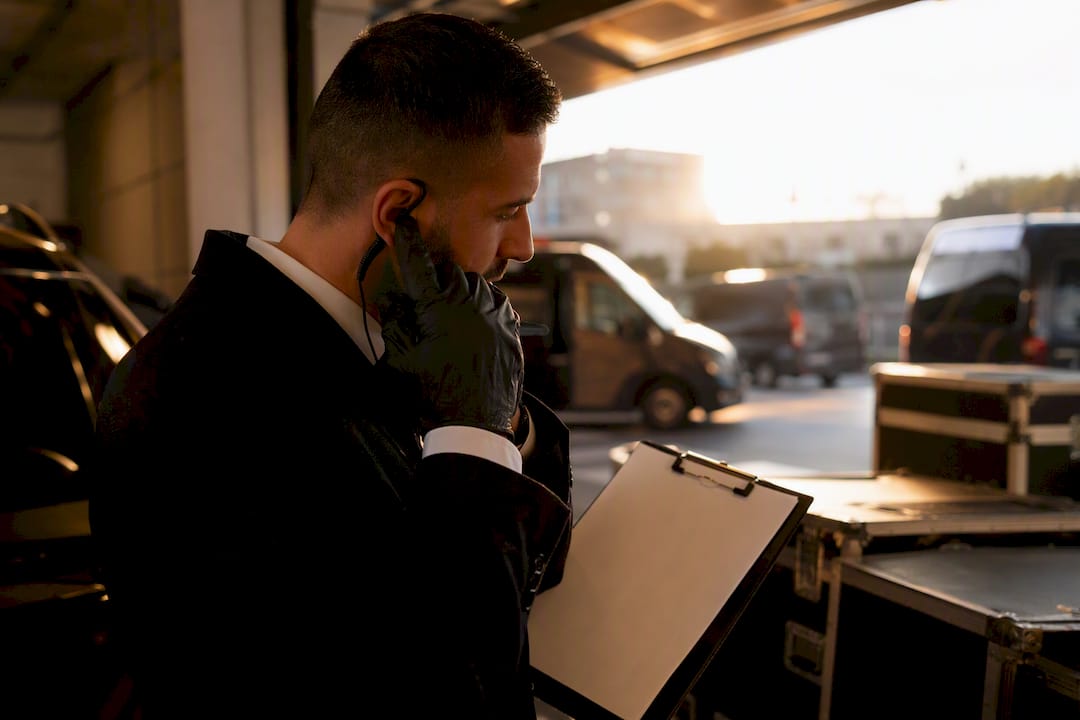 Chauffeur adjusting radio earpiece backstage