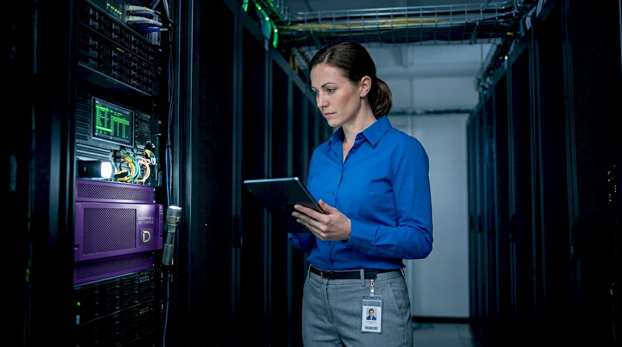 Systems engineer inspecting server racks