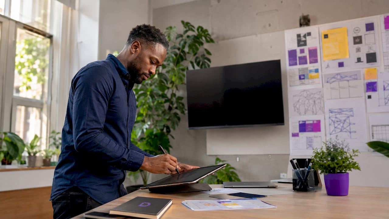 Web designer adjusting UI on graphic tablet