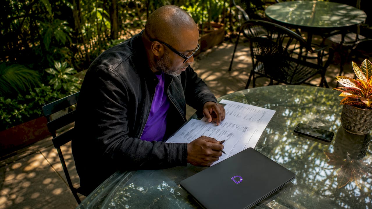 Hands auditing email accounts on paper checklist