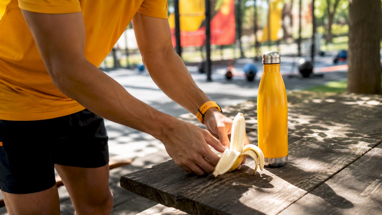 Athlete hands holding banana for quick carb intake