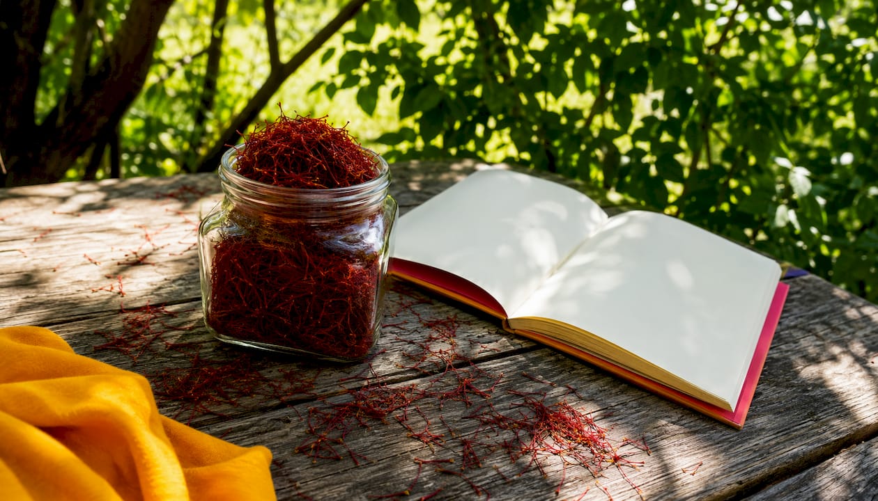 Jar of saffron stigmas with mortar and pestle