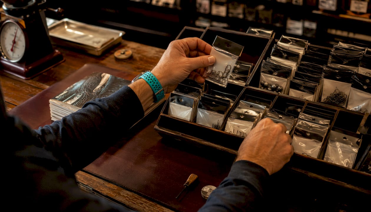 Fisherman selecting tackle at shop counter