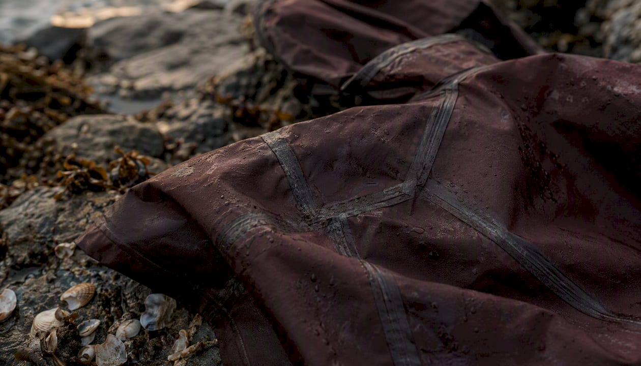 Wet waterproof jacket detail with taped seams on boat deck