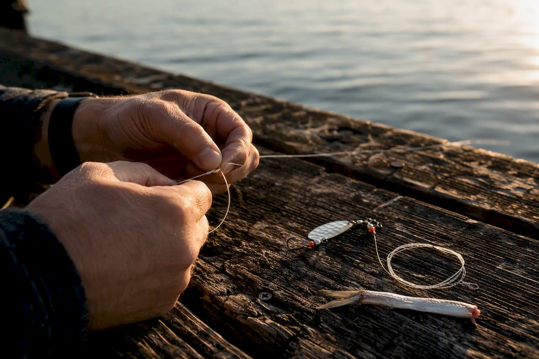 Hands tying FG knot on Chinook trolling rig