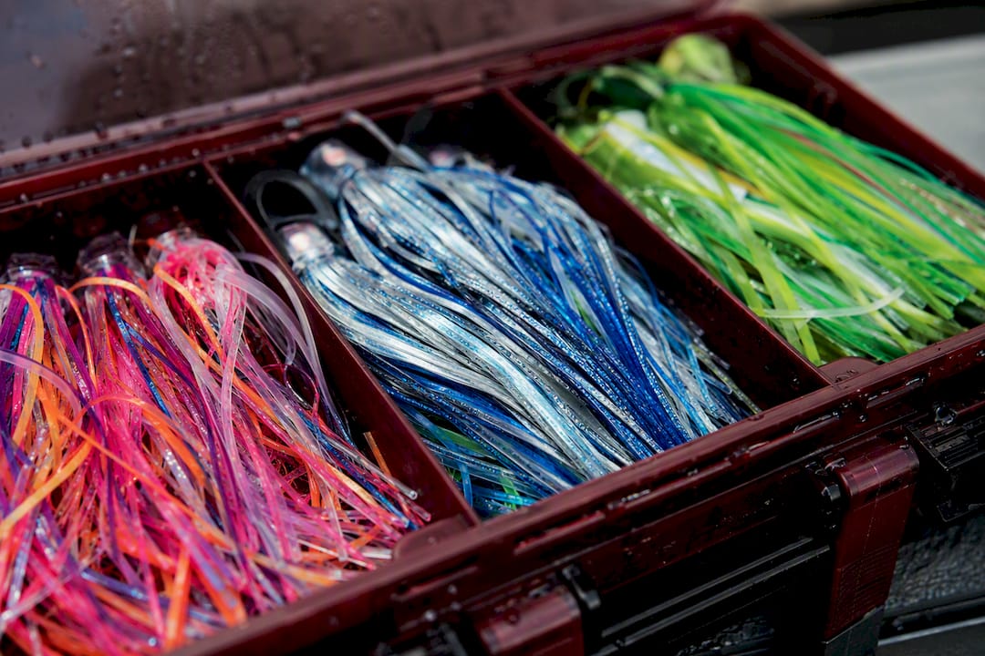 Fishing tackle box with colorful hoochie skirts