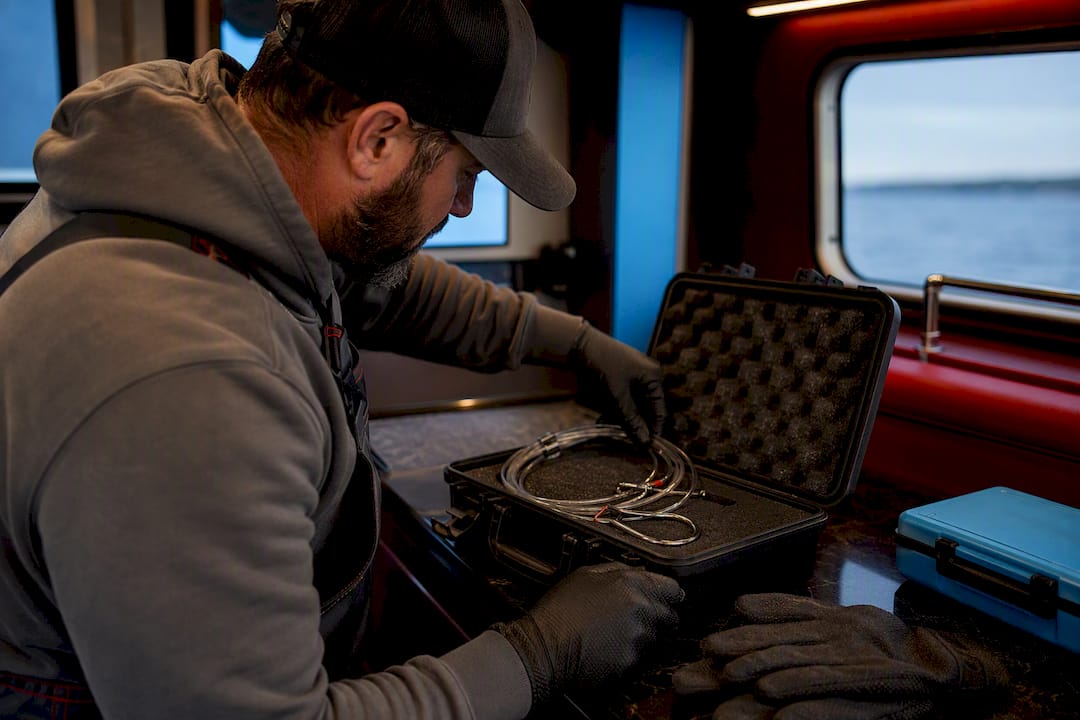 Gloved angler storing halibut leader safely