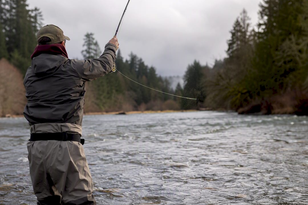 Angler twitching hoochie in river