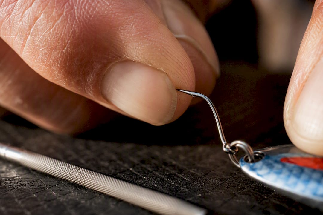 Angler checking a kokanee hook point