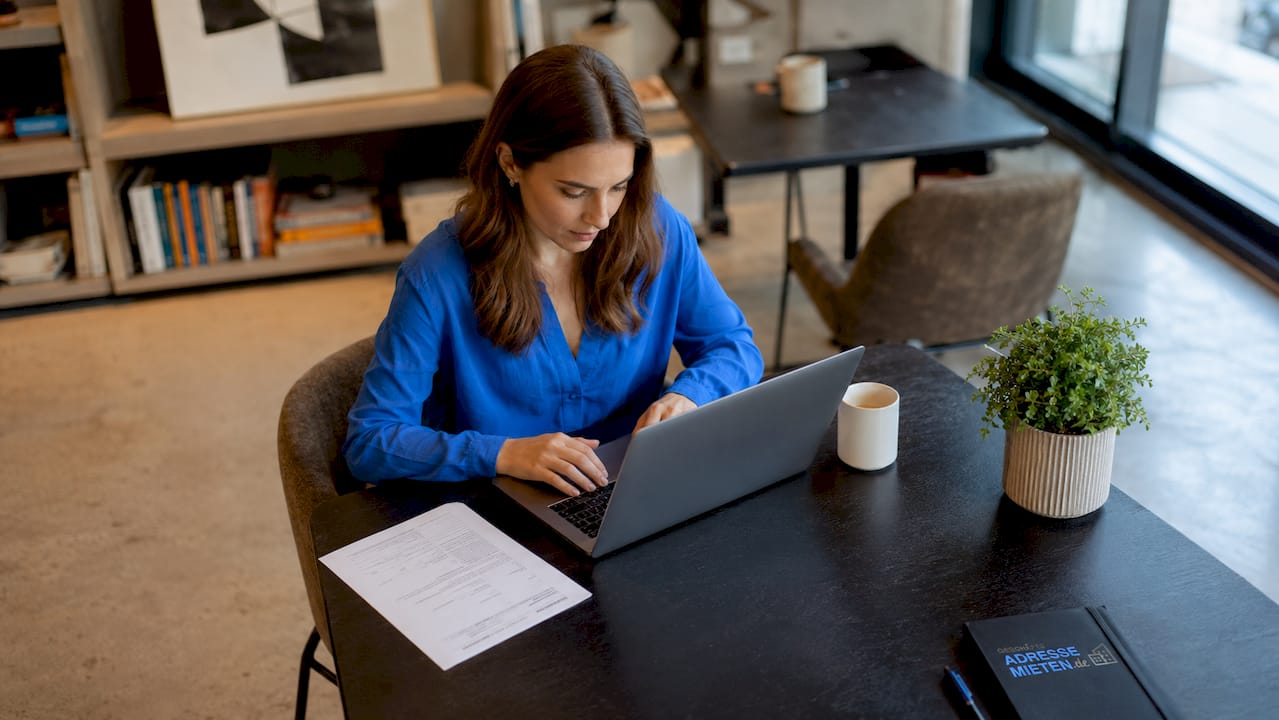 Eine Freelancerin prüft das Impressum auf ihrem Laptop.